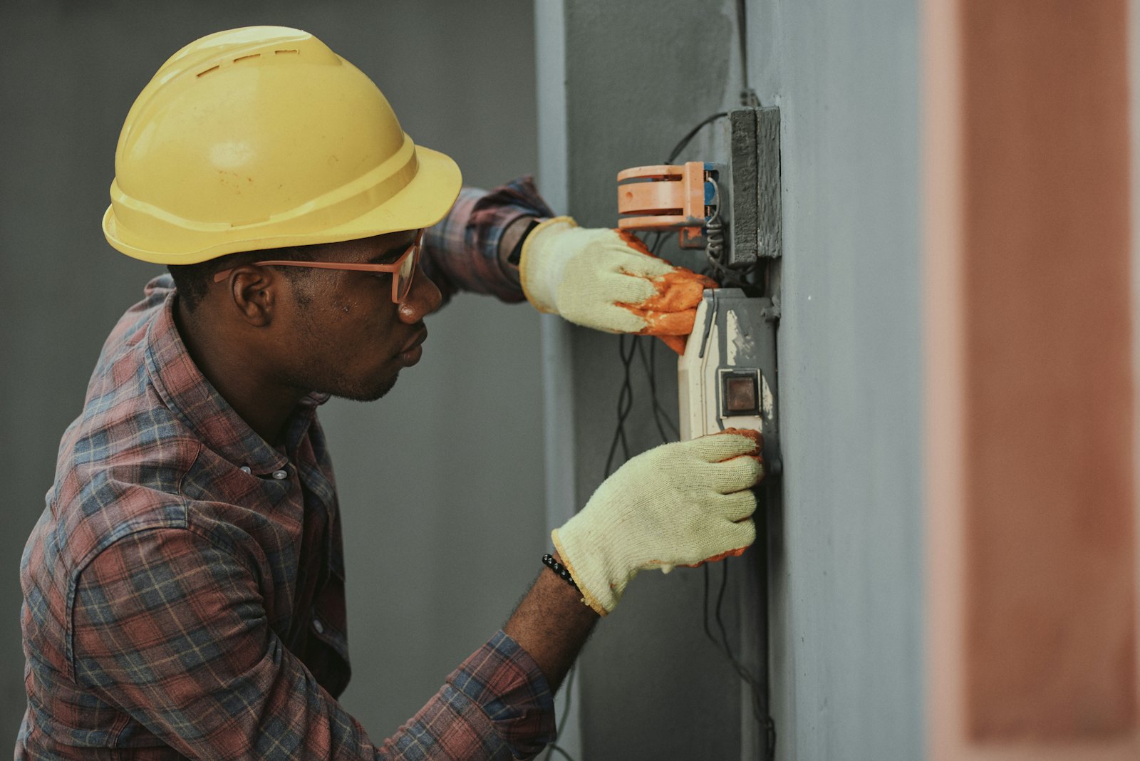 An electrical contractor on site with a tablet, NextStep branding subtly in the scene