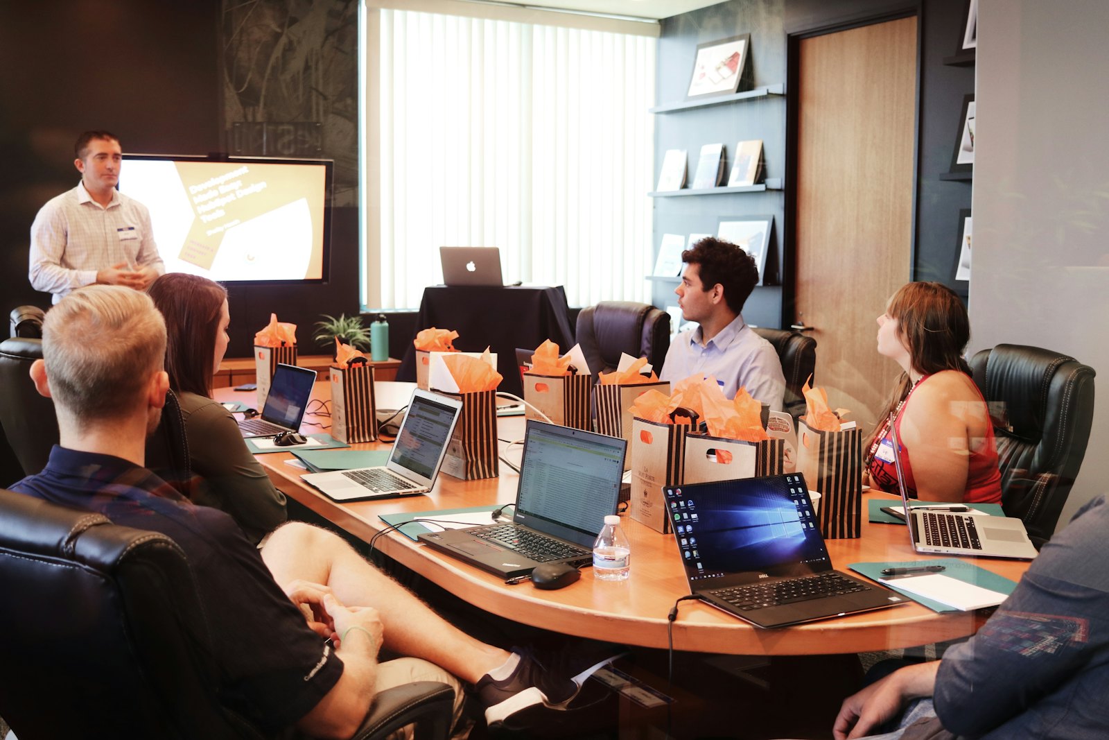 The NextStep workspace: the team at work in a calm, modern office, NextStep branding on the wall